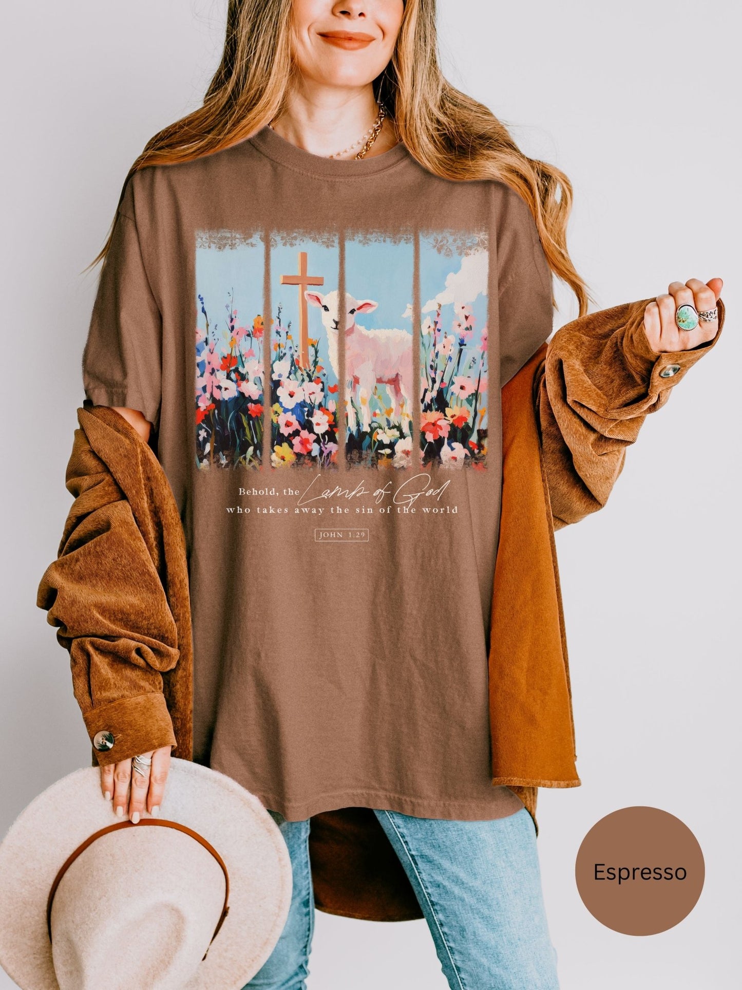 a woman wearing a brown shirt with a cross on it