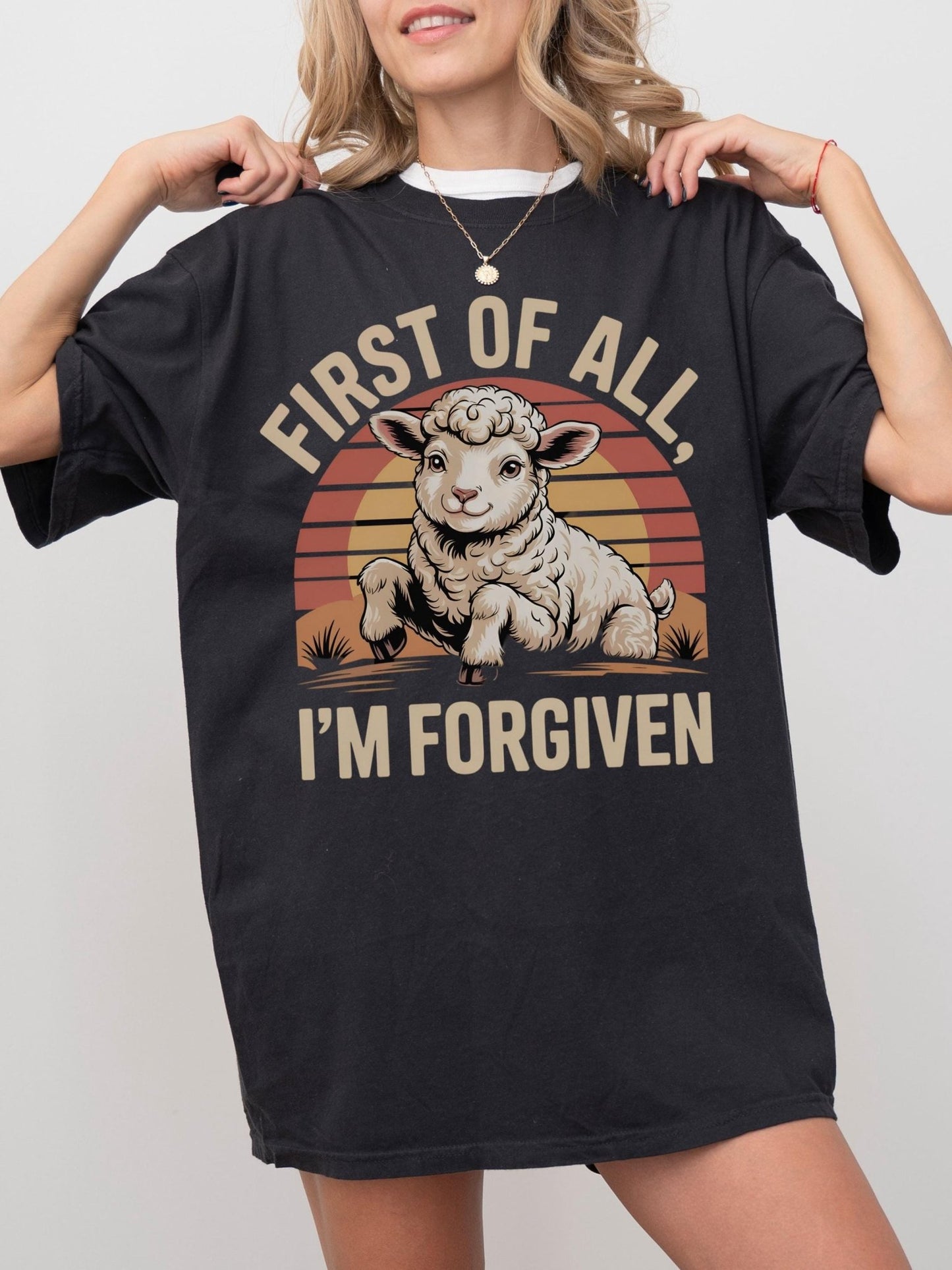 a woman wearing a black shirt that says first of all i'm forgi