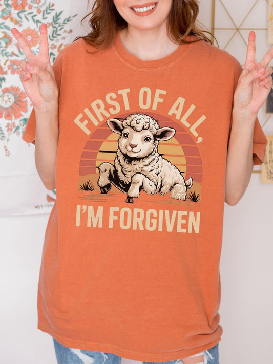 a woman wearing an orange shirt with a picture of a sheep on it