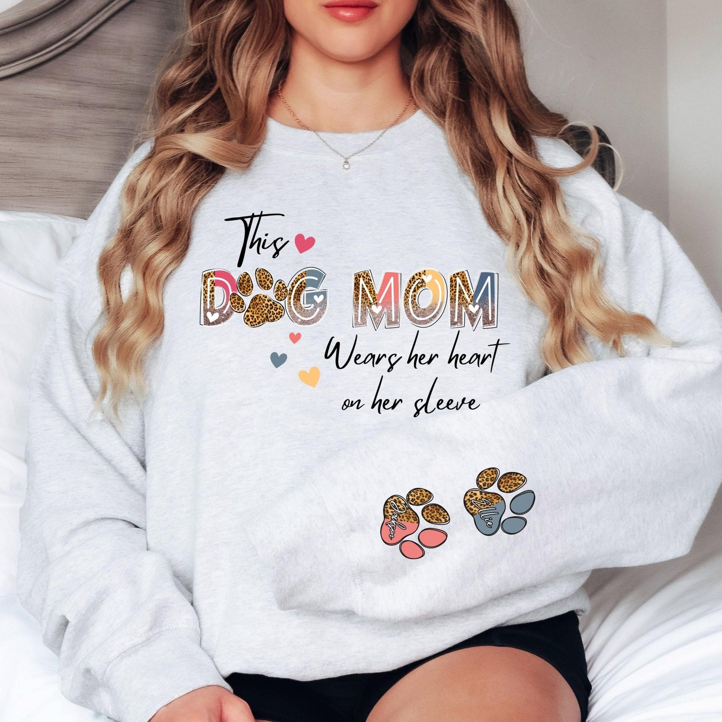 Personalized dog mom hoodie with heart-on-sleeve design, perfect for pet mamas who want a stylish and cozy way to show off their fur babies.