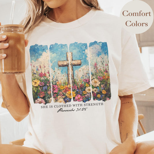 Faith-based Proverbs 31 25 She Is Clothed With Strength shirt featuring a floral cross and oil painting effect perfect for Christian women