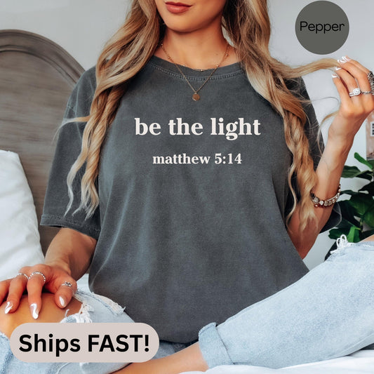 Religious Comfort Colors tee with scripture quote from Matthew 5 14 Be The Light printed on soft cotton ideal for women of faith or Christian gifting