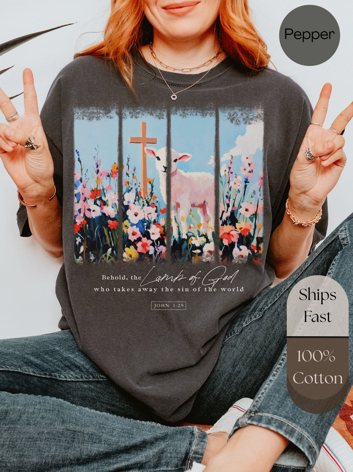 a woman sitting on the ground with a cross on her shirt