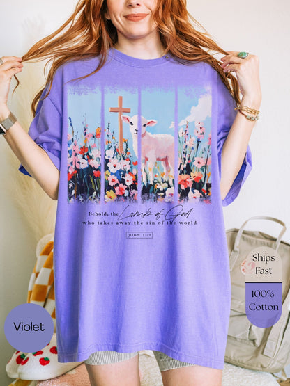 a woman wearing a purple shirt with a cross on it
