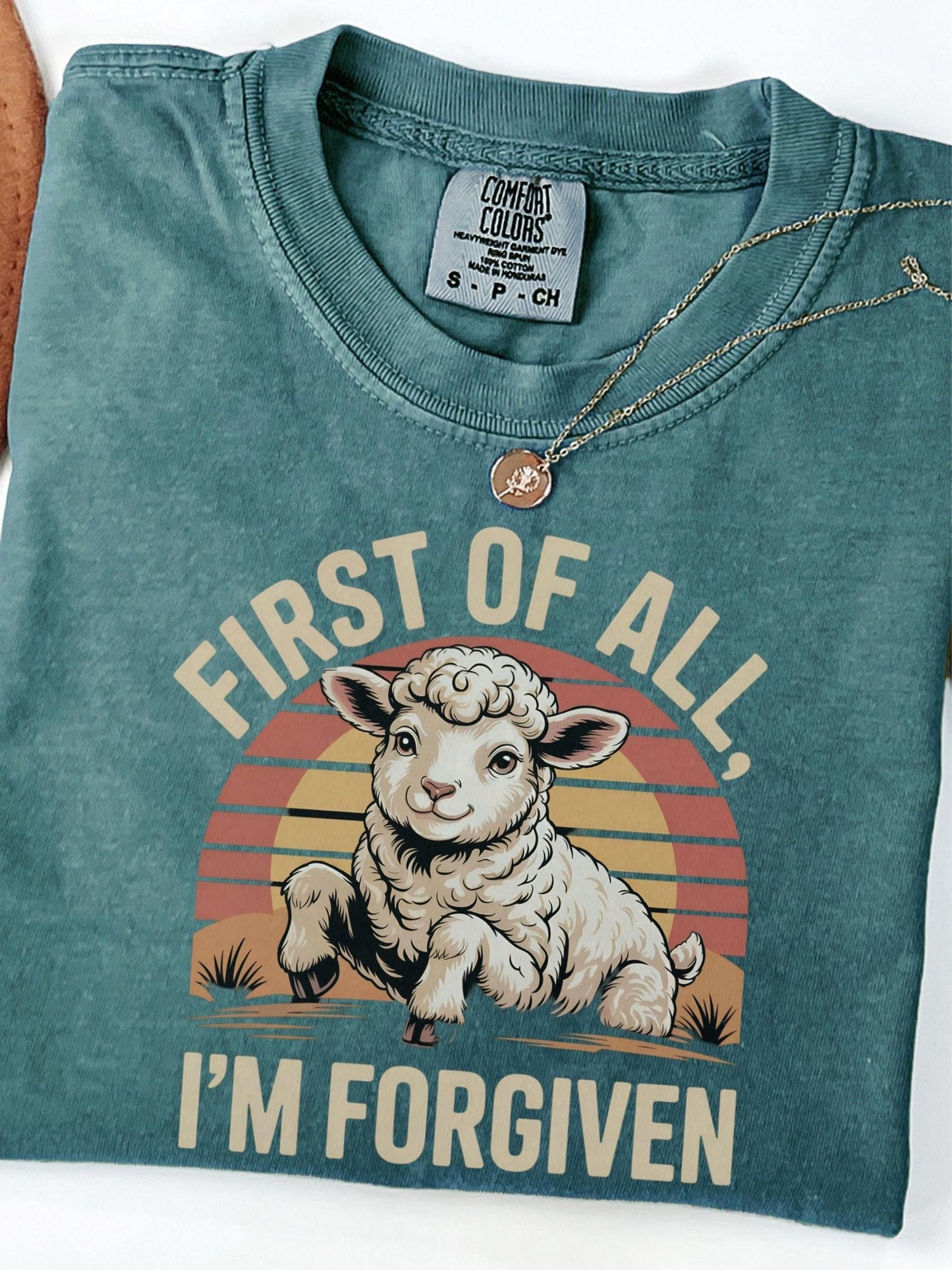 a green shirt with a picture of a sheep on it