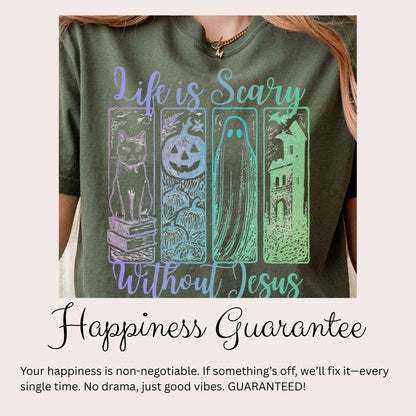 The image is a close-up of a person wearing a green t-shirt with a graphic design featuring a cat, a ghost, and a castle. The text on the t-shirt reads &quot;Life is scary without Jesus&quot; and &quot;Happiness guaranteee&quot;.