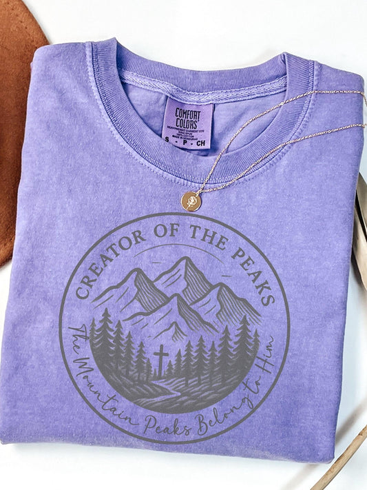 Mountain-themed Christian tee with “The Mountain Peaks Belong to Him” Scripture, ideal for Comfort Colors fans, campers, or outdoor church retreats.