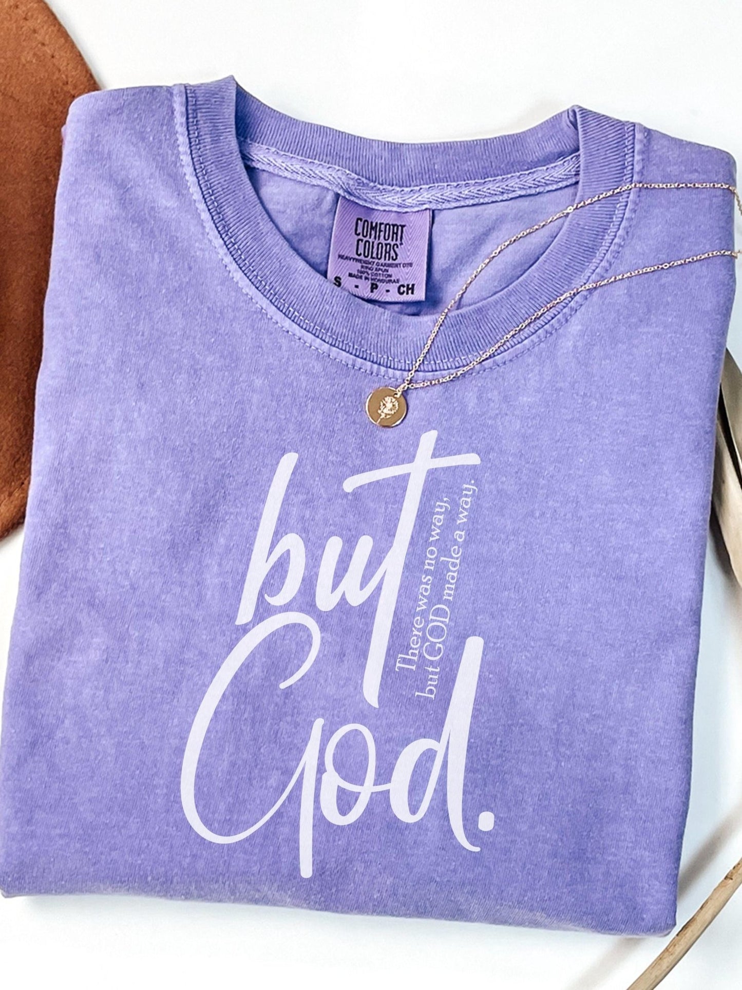 Oversized Christian graphic tee in earthy tones with bold typography saying But God made a way ideal for believers seeking stylish religious wear