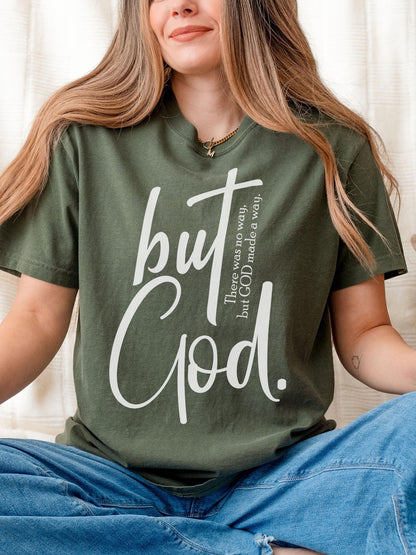 Oversized Christian t-shirt featuring But God quote in large script font on soft moss green fabric perfect for Jesus lovers and faith driven fashion