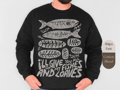 a black long-sleeved shirt with a graphic design depicting fish and leaves, along with the text &quot;I&#39;LL GIVE YOU ALL OF MY FISHES AND LOAVES&quot; printed on it.