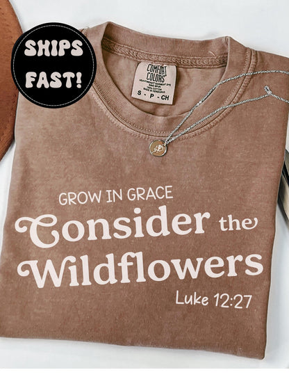 Christian t-shirt with wildflower and Bible verse design, displayed as a gift for women of faith