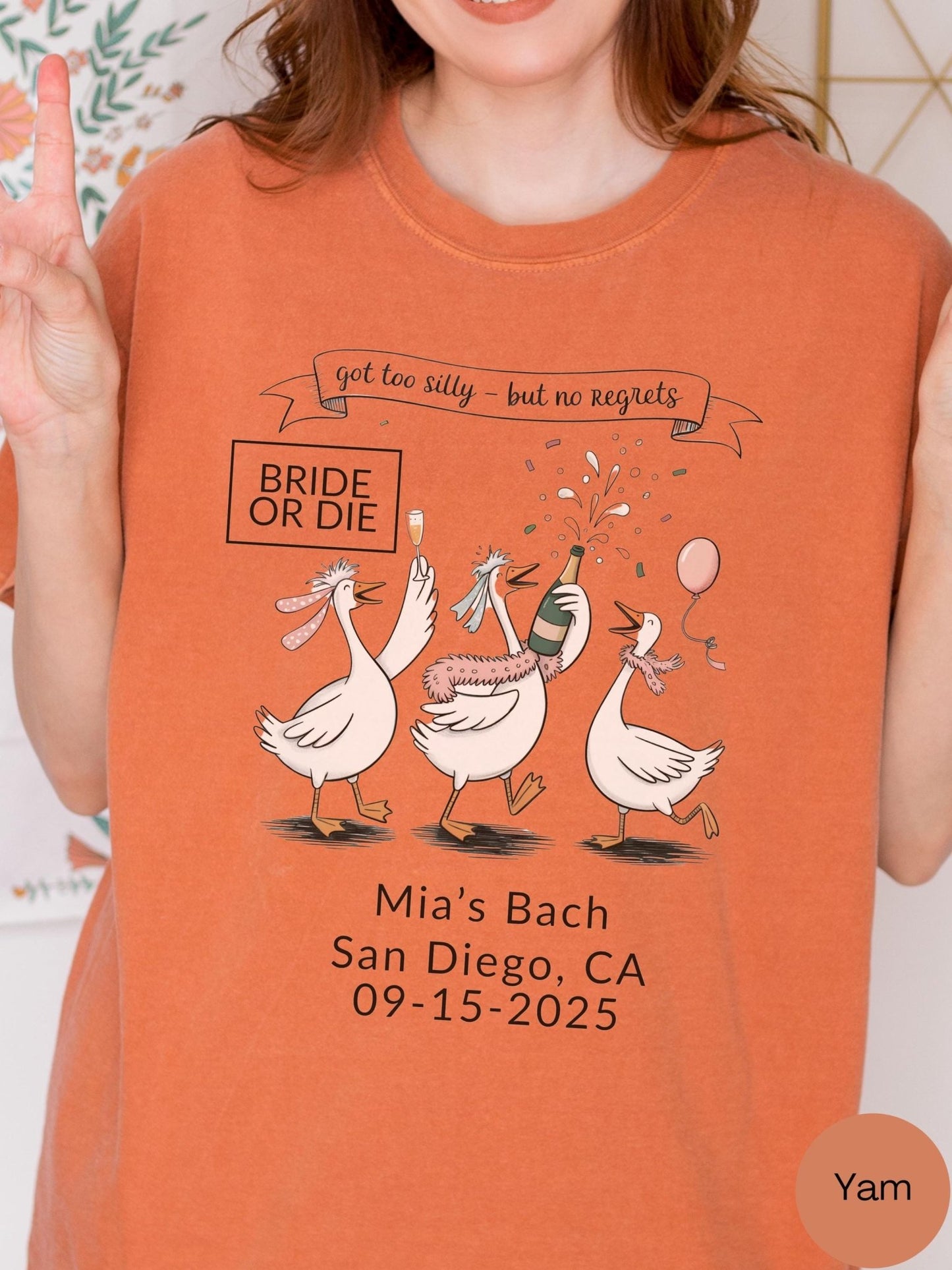 a woman wearing a t-shirt with a graphic design of three cartoon geese, along with text that reads &quot;Mia&#39;s Bach San Diego, CA 09-15-2025&quot;.