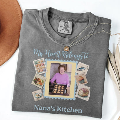 a gray t-shirt with a personalized design, including a photo of a woman and various food-related items such as cakes and a bowl.