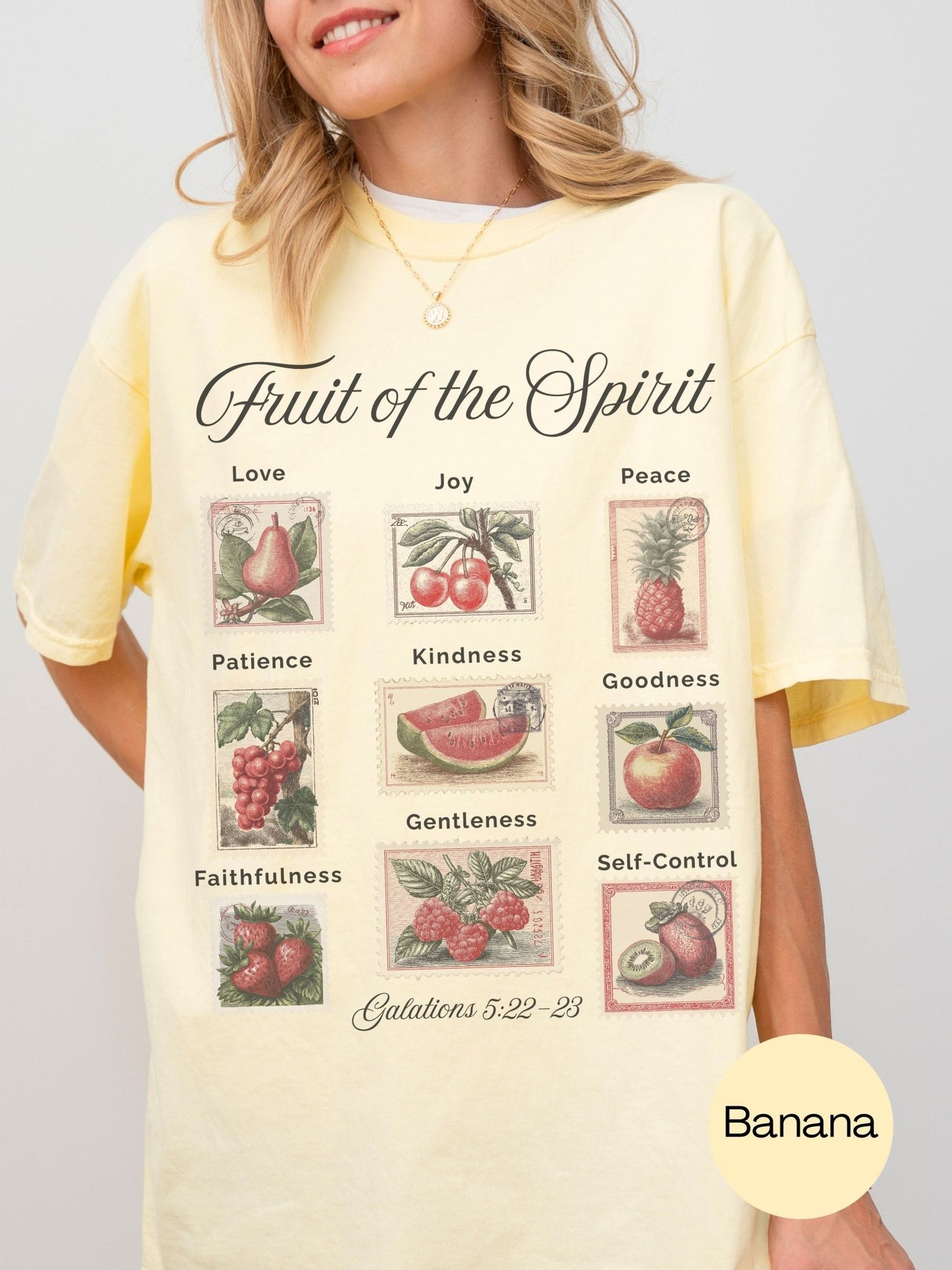 A woman wearing a yellow t-shirt with a graphic design depicting various fruits and their associated Bible verse.