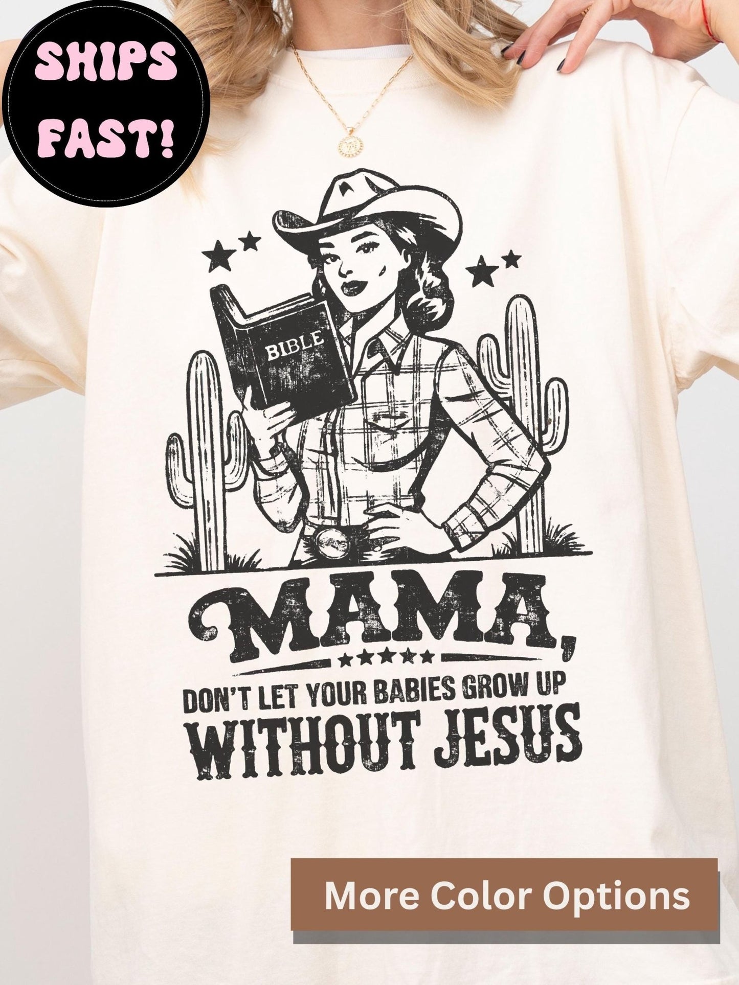 A white t-shirt with a graphic design featuring a woman in a cowboy hat holding a Bible, along with the text "MAMA, DON'T LET YOUR BABIES GROW UP WITHOUT JESUS".