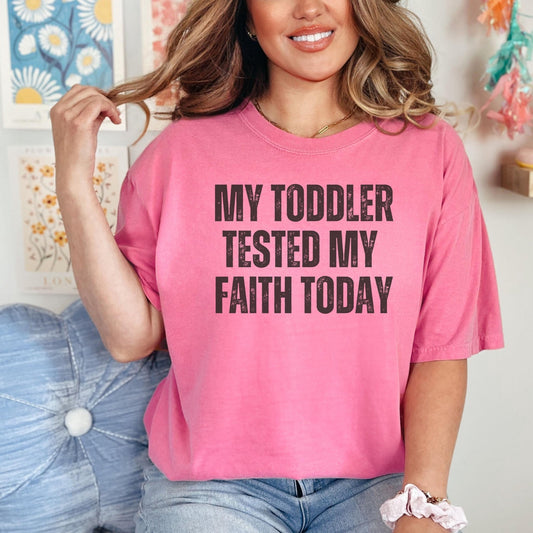 A relatable mom humor shirt designed for mothers who need a little faith and laughter in their day featuring bold typography and a comfortable fit ideal for casual wear and thoughtful gifting