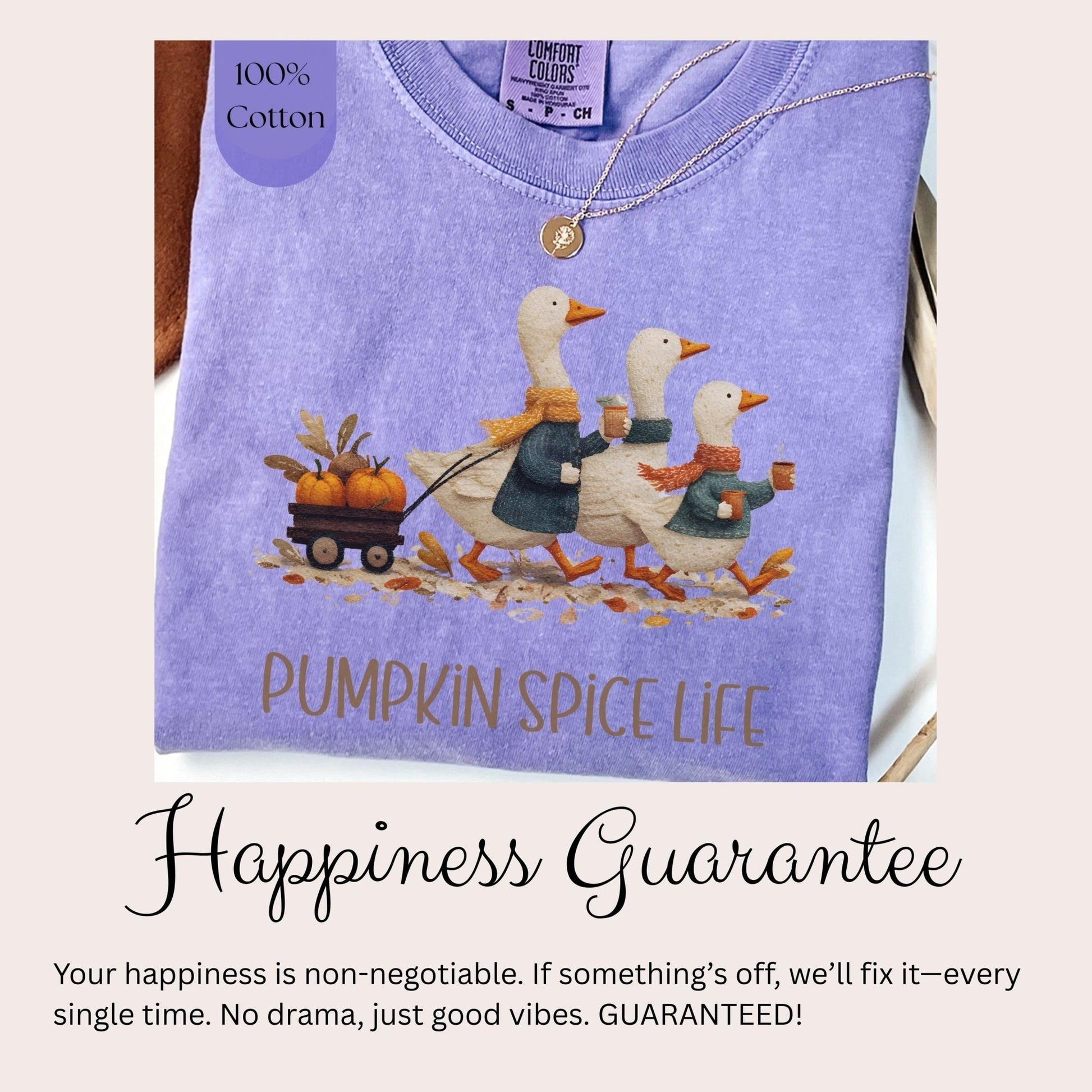 A purple t-shirt with a graphic of three white ducks walking on a path, carrying pumpkins, and the text &quot;PUMPKIN SPICE LIFE&quot; printed on it.