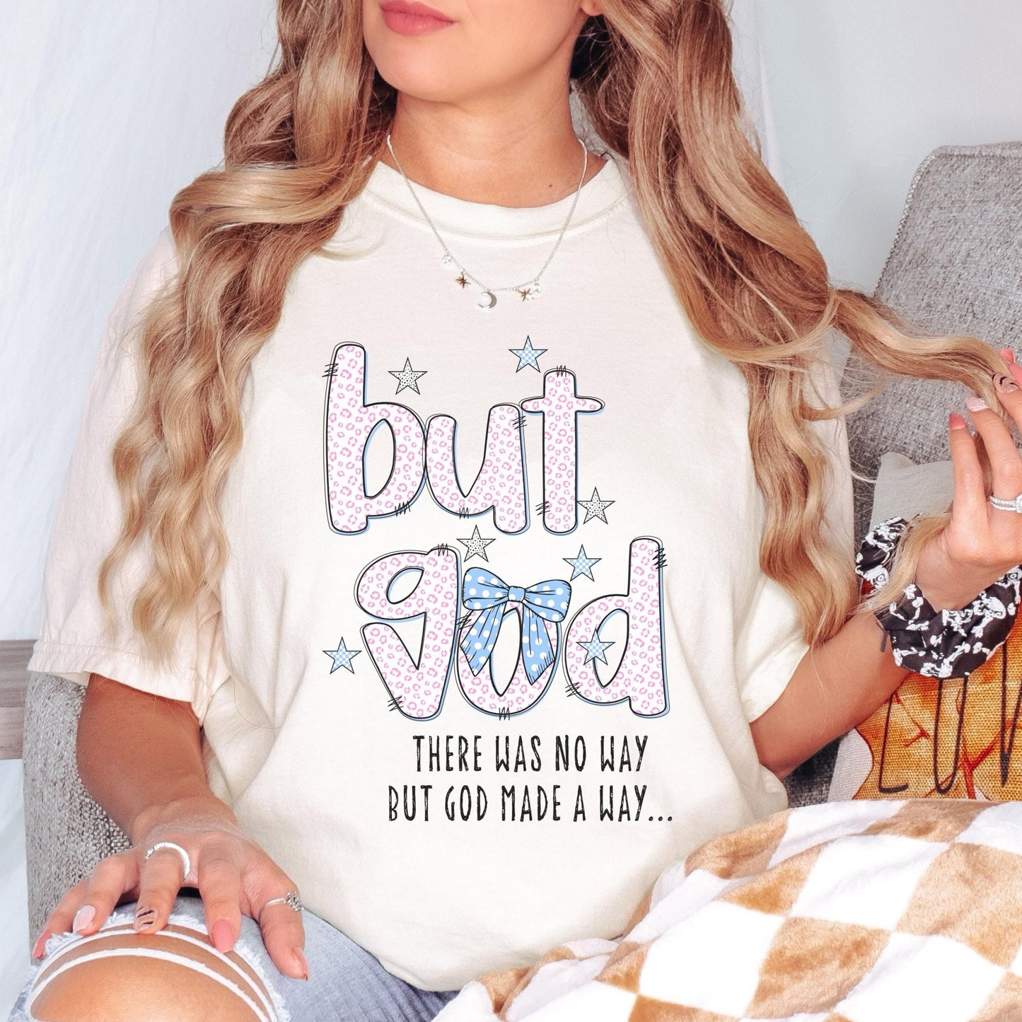 A woman wearing a white t-shirt with a graphic design and text printed on it.
