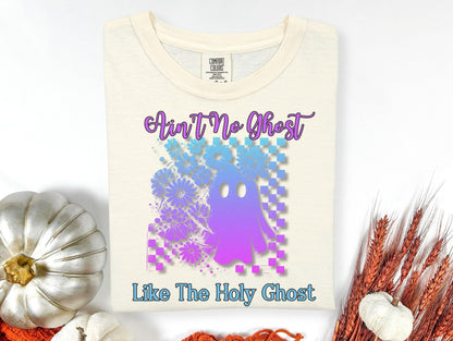 a white t-shirt with a graphic design of a purple and blue ghost surrounded by flowers, along with the text "Ain't No Ghost Like The Holy Ghost".
