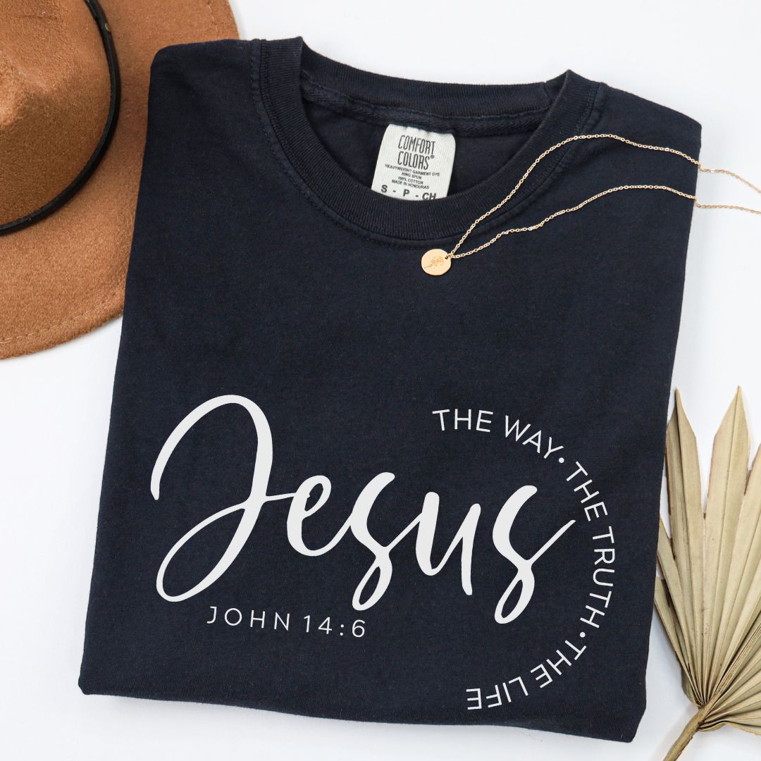 A black t-shirt with white text and a gold necklace are displayed on a white background.