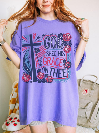 Christian July 4th tee with God and country theme featuring red white and blue stars floral elements and inspirational faith quote