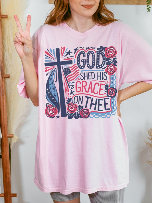 Christian patriotic tee for women featuring God Shed His Grace on Thee message with boho floral and American flag perfect for 4th of July or faith-based Independence Day outfit