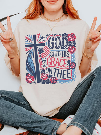 USA faith shirt with floral cross and God Shed His Grace design printed on soft cotton perfect for 4th of July gift or church celebration