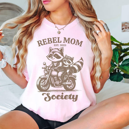 Rebel Mom Society t-shirt featuring a cute raccoon motorcycle graphic, designed for bold moms who love a trendy Comfort Colors graphic tee with a custom “Est” year print