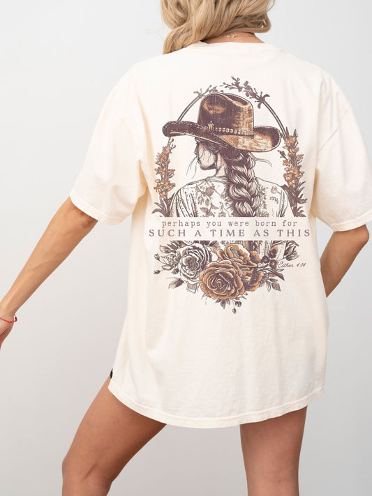 a woman wearing a white shirt with a cowboy hat on it