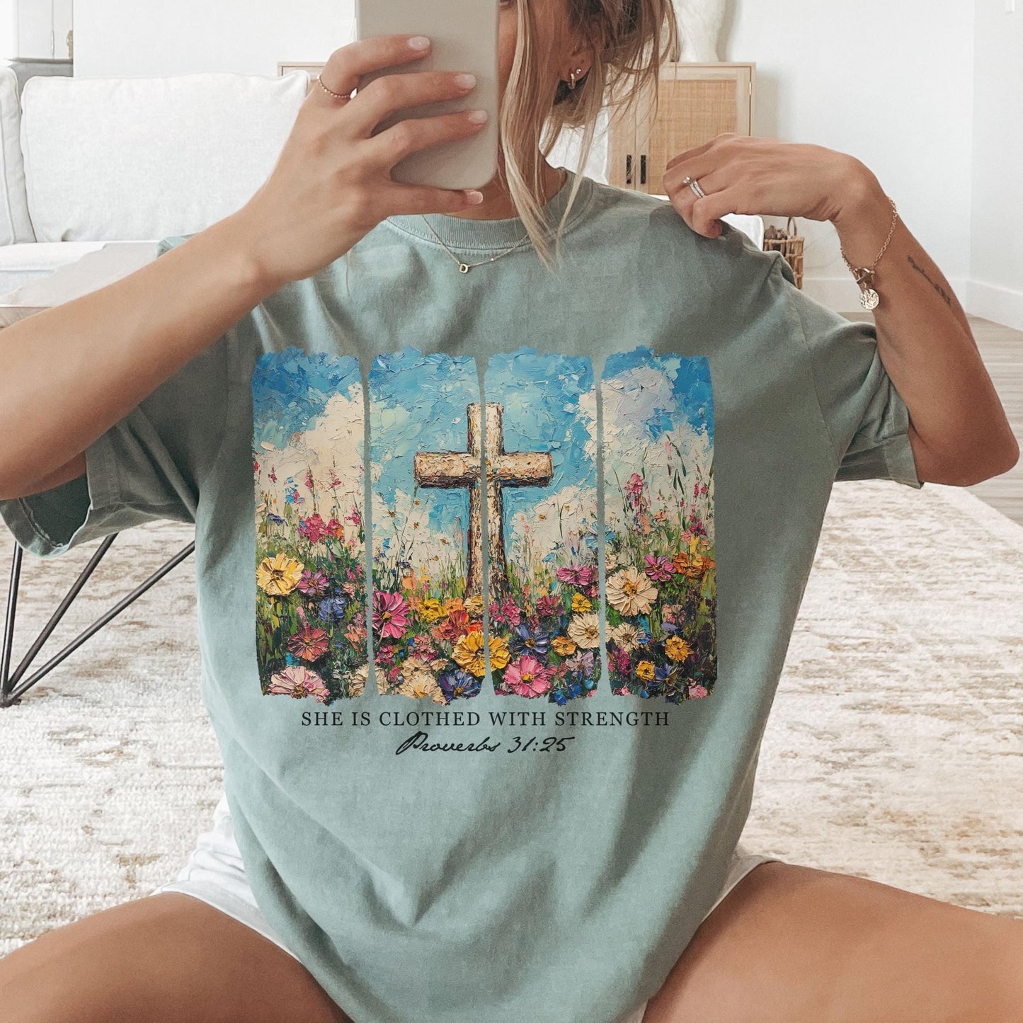 Beautiful floral cross t-shirt with She Is Clothed With Strength Bible verse perfect for Christian gifts and faith-based fashion